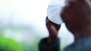 African man putting epidemic mask prevention, black man wearing covid mask looking to camera