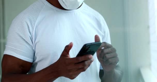 African Black Man Using Cellphone Working Home Pandemic Wearing Covid — Vídeos de Stock