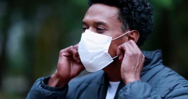 Black African American Man Removing Covid Face Mask Outdoors Smiling — Video