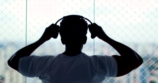 Person Putting Headphones Indoors Listening Song Podcast Audiobook — Vídeo de stock