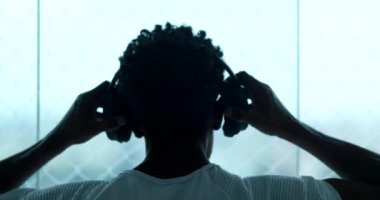 Man putting headphones listening to song