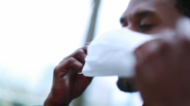 African american putting on surgical mask outbreak prevention. Black man puts covid epidemic mask