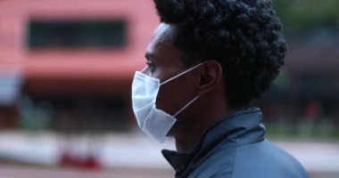 Man walking in city wearing covid-19 face mask outbreak pandemic prevention