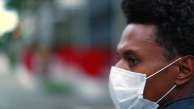 Back of person walking in slow-motion in city wearing covid pollution mask pandemic prevention