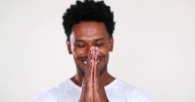 Compassionate black African man smiling camera giving thanks an d being grateful portrait