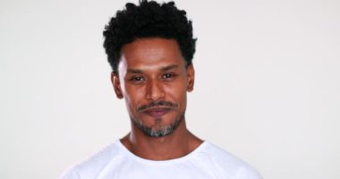 Happy charismatic handsome black guy smiling to camera giving faith sign with hands, feeling compassionate