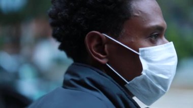 Black african man wearing pollution mask in city evening
