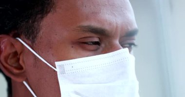Black african american man wearing virus mask close-up face and eyes