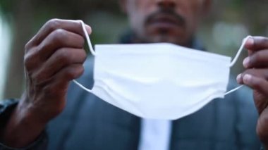 African american putting on outbreak mask prevention outside