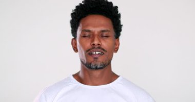 African man feeling relief in mindful meditation and contemplation. Black person smiling free from pain