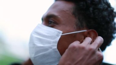 Black man removing surgical mask closeup face