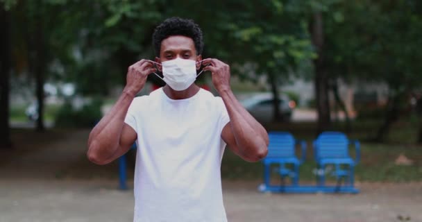 Афроамериканец Надевает Хирургическую Маску Вне Профилактики Пандемии — стоковое видео