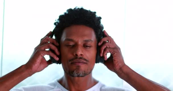 African American Man Putting Headphones Listening Music — Stok video