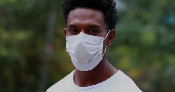 African American Standing Looking Camera Wearing Covid Surgical Mask Pandemic — стоковое видео