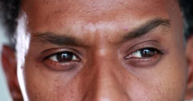 Person thinking about solution, african man brainstorming ideas, looking for answers, close-up of eyes