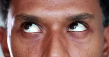 Extreme close-up of african american man eyes looking up , down and sideways