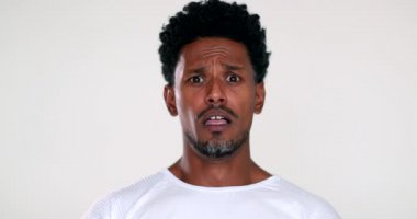 African man reacting with terror and horror to camera, black guy shock reaction