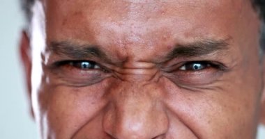 Person feeling disgust emotion, African man grimacing in distaste. black guy disliking close-up face