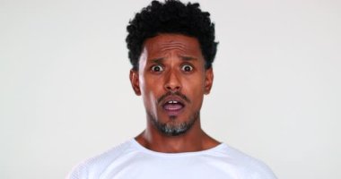 African american gradual shock reaction, face emotion black guy reacting with horror putting hand in mouth with surprise