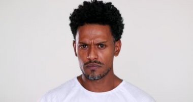 Suspicious black African man reaction to camera. Portrait guy reacting with surprise