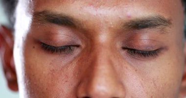 African american man opening eyes close-up looking to camera