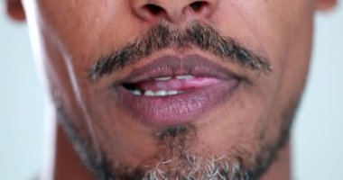 Man sticking tongue out, african descent mixed race tongue out close-up mouth