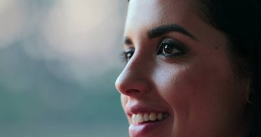 Close-up of hispanic latina beautiful young woman closing and opening eyes in contemplation