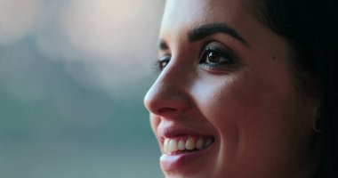 Close-up of hispanic latina beautiful young woman closing and opening eyes in contemplation