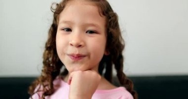 Cute diverse little child girl sending kiss to camera
