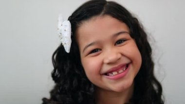 Happy little girl child smiling and feeling joy, hispanic mixed race asian kid