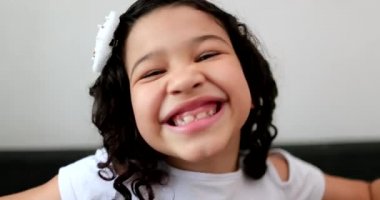 Happy joyful biracial little child girl smiling
