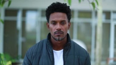 Serious african man walking forward towards camera. Confident black guy portrait moving forward
