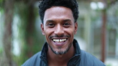 black guy african descent smiling to camera handsome man walking forward