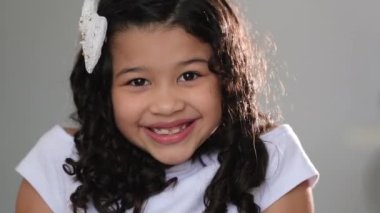 Little girl child posing and smiling at camera