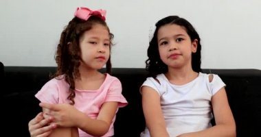 Two little girl speaking to camera in video conference. small sisters recording video