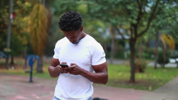 Man Looking Cellphone Standing Park Mixed Race Guy Holding Smartphone — Stock videók