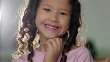 Cute hispanic mixed race asian little girl child sending kiss to camera