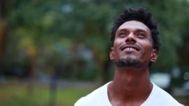 Circling around african american man looking up with steadicam