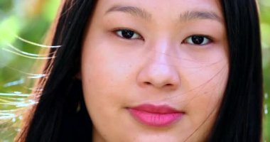 Happy young asian woman smiling at camera, close-up portrait face