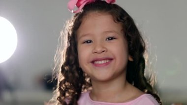 Cute little girl child giving thumbs up to camera