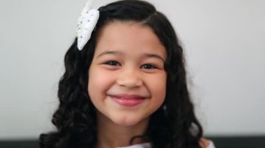 Happy little girl child smiling and feeling joy, hispanic mixed race asian kid