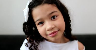 Ethnically diverse little child girl looking at camera portrait