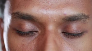 Macro african american man eyes close-up. Black person opening eyes smiling