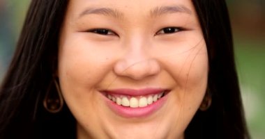 Happy Asian large young woman smiling at camera close-up portrait face