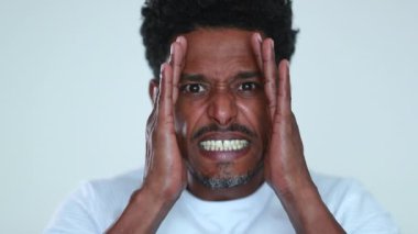 African american man reacting with SHOCK and horror to news, person covering face feeling distraught emotion