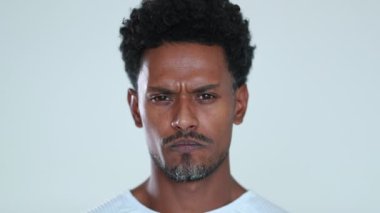 African man becoming serious thinking being pensive and thoughtful about idea, changing mood and celebrating