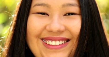 Young fat Asian woman smiling, close-up portrait face. Casual real people