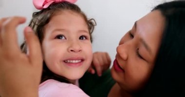 Cute little girl hugging and loving mom. Candid authentic affection and love between mother and child