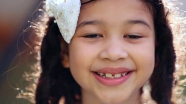 Little girl child close-up face. Hispanic mix race asian kid