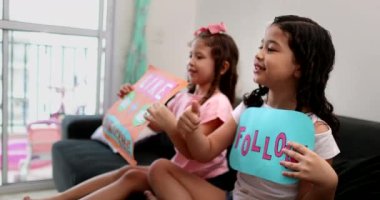 Two little sisters asking audience to subscribe and like channel